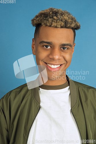 Image of African-american man\'s portrait isolated on blue studio background