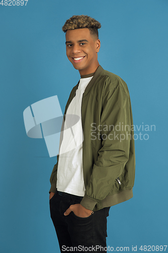 Image of African-american man\'s portrait isolated on blue studio background