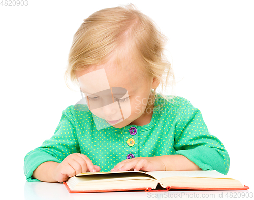 Image of Little girl is reading her book