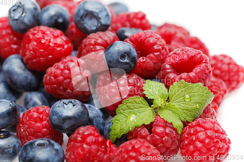 Image of blueberry and raspberry berries isolated on white background