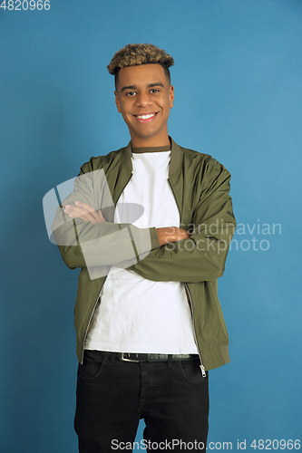 Image of African-american man\'s portrait isolated on blue studio background