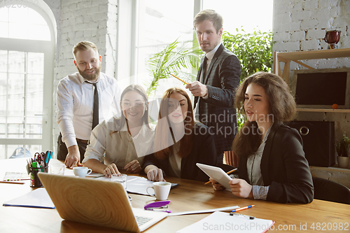 Image of Group of young business professionals having a meeting, creative office