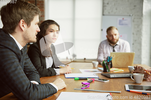 Image of Group of young business professionals having a meeting, creative office