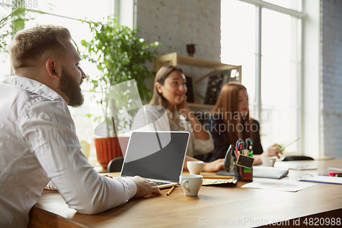 Image of Group of young business professionals having a meeting, creative office