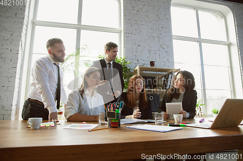 Image of Group of young business professionals having a meeting, creative office