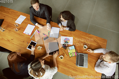 Image of Group of young business professionals having a meeting, creative office