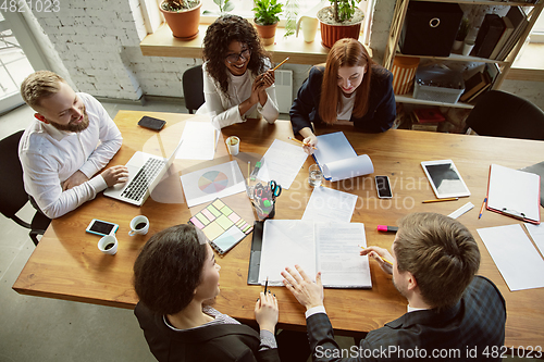 Image of Group of young business professionals having a meeting, creative office