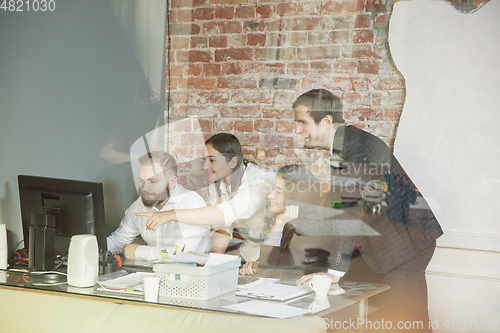 Image of Group of young business professionals having a meeting, creative office