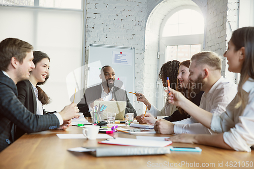 Image of Group of young business professionals having a meeting, creative office