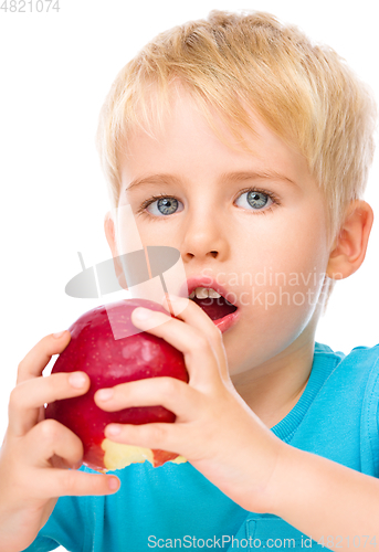 Image of Portrait of a cute little boy with red apple