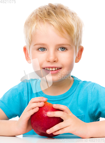 Image of Portrait of a cute little boy with red apple
