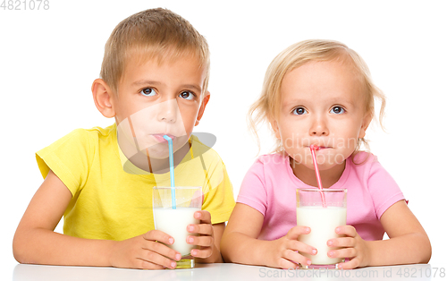 Image of Cute little girl and boy are drinking milk