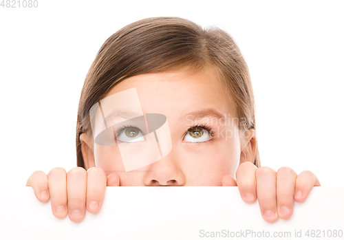 Image of Little girl is looking from out blank board