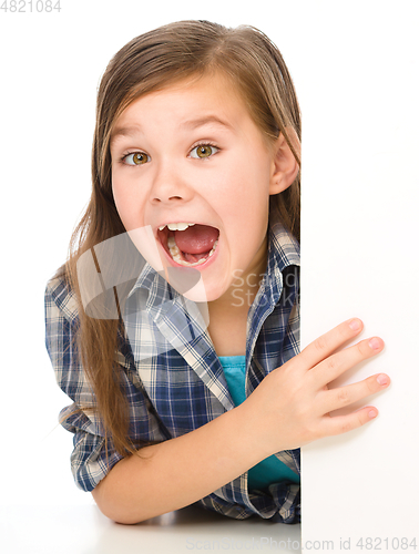 Image of Little girl is looking out from the blank banner