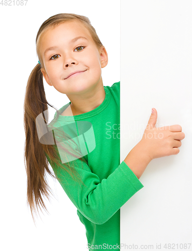 Image of Little girl is looking from out blank board