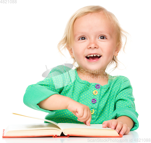 Image of Little girl is reading her book