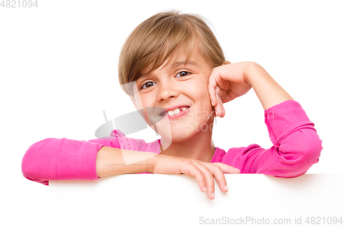 Image of Little girl is looking out from the blank banner