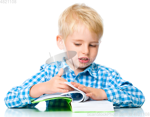 Image of Little child play with book