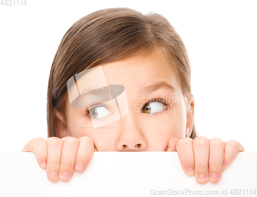Image of Little girl is looking from out blank board