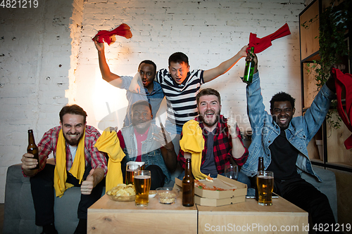 Image of Group of friends watching TV, sport match together. Emotional fans cheering for favourite team, watching on exciting game. Concept of friendship, leisure activity, emotions