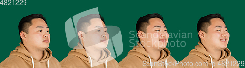 Image of Evolution of emotions. Asian man\'s portrait isolated over green studio background with copyspace