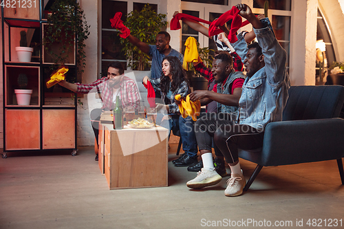 Image of Group of friends watching TV, sport match together. Emotional fans cheering for favourite team, watching on exciting game. Concept of friendship, leisure activity, emotions