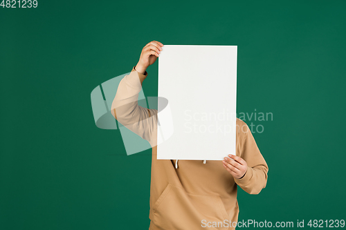 Image of Asian man\'s portrait isolated over green studio background with copyspace