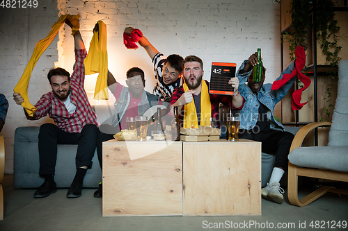 Image of Group of friends watching TV, sport match together. Emotional fans cheering for favourite team, watching on exciting game. Concept of friendship, leisure activity, emotions