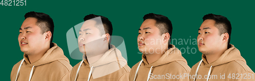 Image of Evolution of emotions. Asian man\'s portrait isolated over green studio background with copyspace