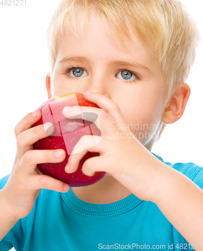Image of Portrait of a cute little boy with red apple
