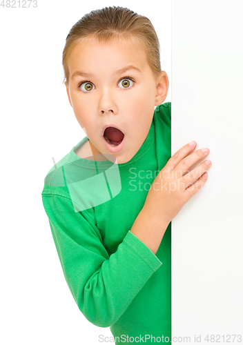 Image of Little girl is looking out from the blank banner