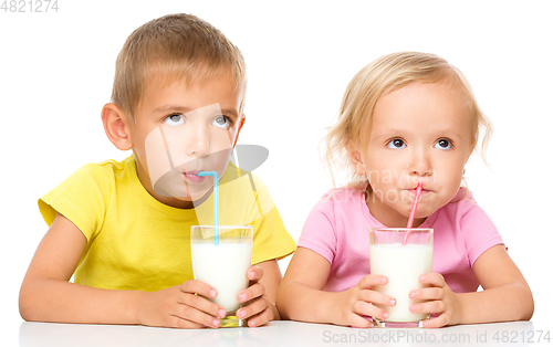 Image of Cute little girl and boy are drinking milk