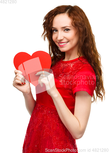Image of Young woman holding red heart
