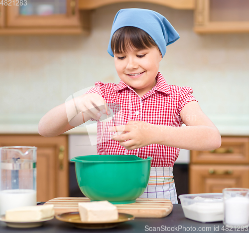Image of Girl is cooking in kitchen