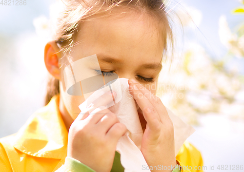 Image of Little girl is blowing her nose