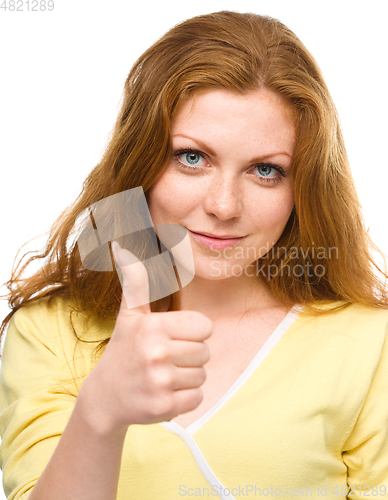 Image of Woman is showing thumb up gesture