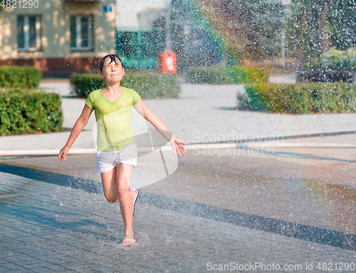 Image of Girl is running through fountains