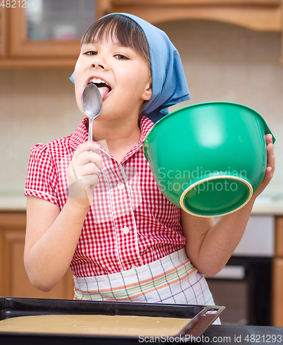 Image of Girl is cooking in kitchen