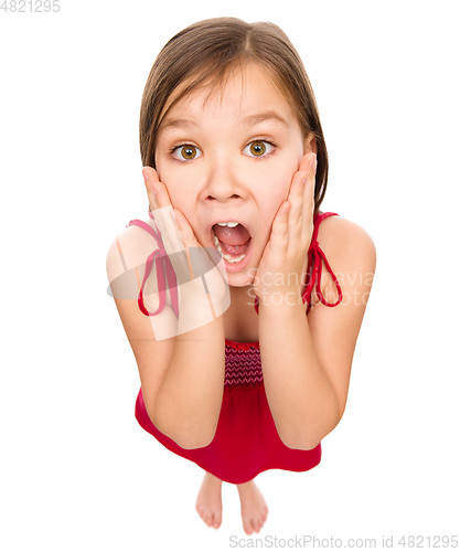 Image of Little girl is holding her face in astonishment