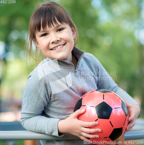 Image of Cute little girl is playing in playground