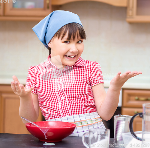 Image of Girl is cooking in kitchen