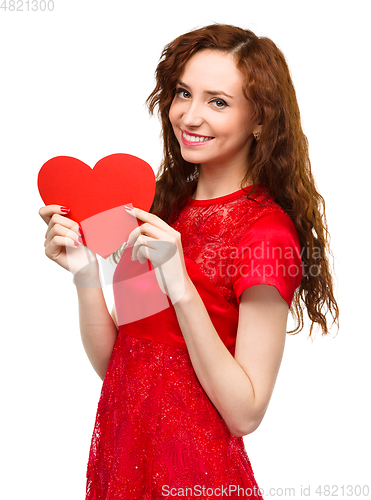 Image of Young woman holding red heart