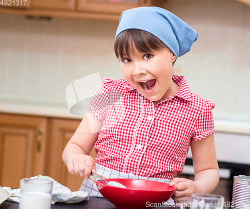 Image of Girl is cooking in kitchen