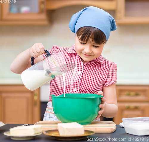 Image of Girl is cooking in kitchen