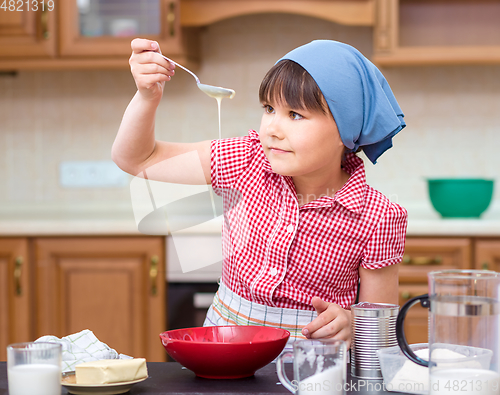Image of Girl is cooking in kitchen