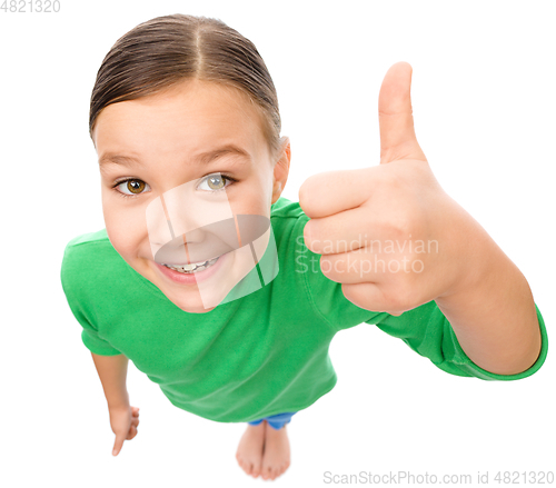 Image of Little girl is showing thumb up gesture