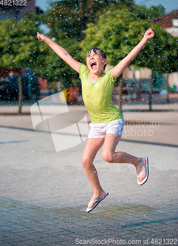 Image of Girl is running through fountains