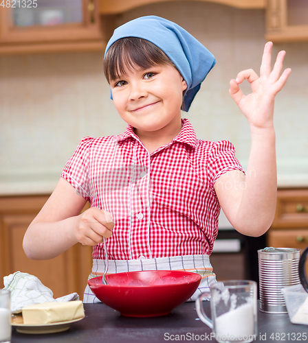 Image of Girl is cooking in kitchen