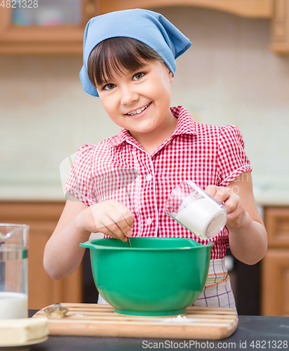 Image of Girl is cooking in kitchen