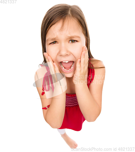 Image of Little girl is holding her face in astonishment